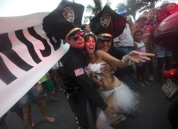 Revelers pose for photos during the Banda de Ipanema block parade, a pre-Carnival event, in Rio de Janeiro, Brazil.