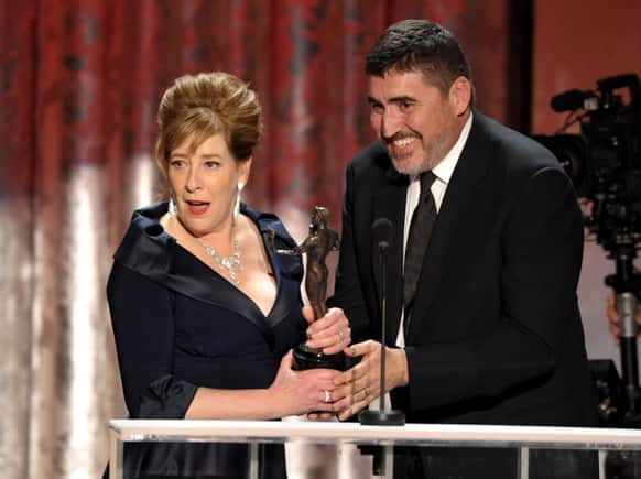 Phyllis Logan, left, accepts the award from Alfred Molina for outstanding ensemble in a drama series for “Downton Abbey” at the 19th Annual Screen Actors Guild Awards at the Shrine Auditorium.