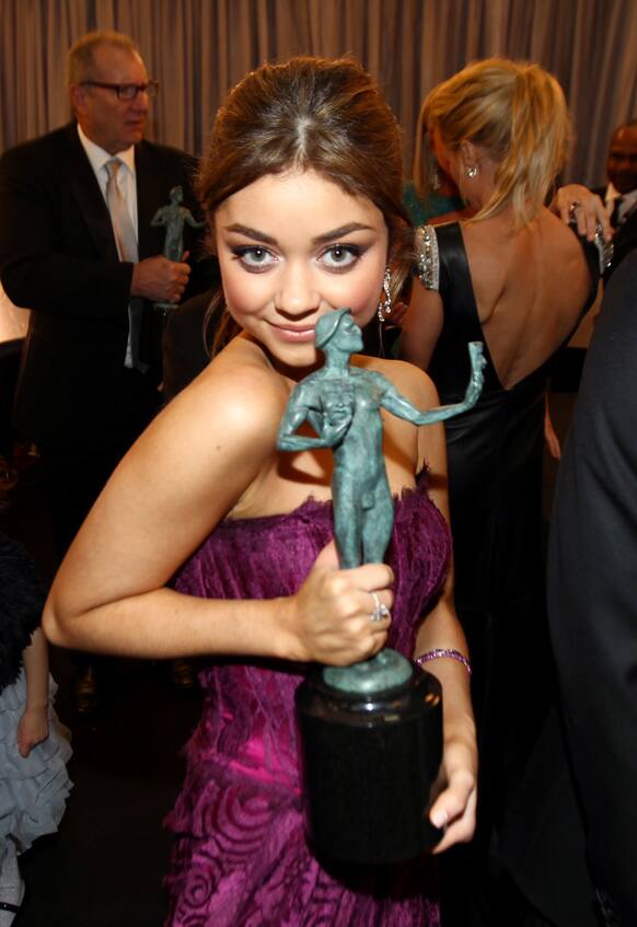 Actress Sarah Hyland poses backstage with the award for outstanding ensemble in a comedy series for “Modern Family” at the 19th Annual Screen Actors Guild Awards at the Shrine Auditorium.