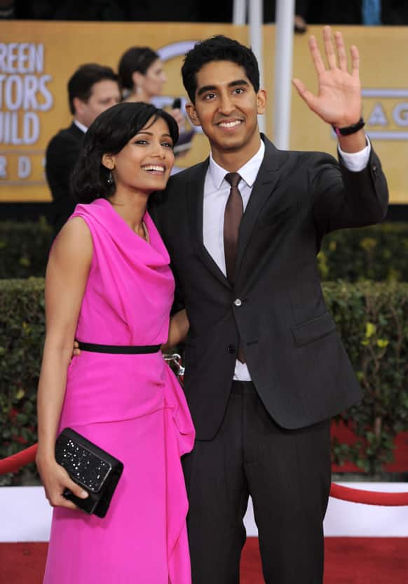 Freida Pinto, left and Dev Patel arrive at the 19th Annual Screen Actors Guild Awards at the Shrine Auditorium.