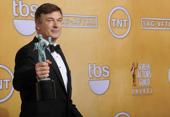 Actor Alec Baldwin poses backstage with the award for best male actor in a comedy series at the 19th Annual Screen Actors Guild Awards at the Shrine Auditorium.