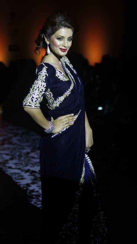 Bollywood actress Geeta Basra displays a creation by Archana Kocchar at the Bangalore Fashion Week.