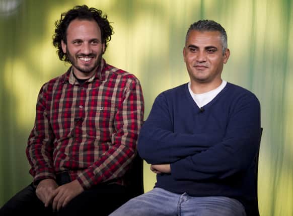 Documentary film co-directors Israeli Guy Davidi, left, and Palestinian Emad Burnat pose for a photo after an interview in Los Angeles.