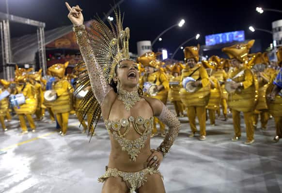 A dancer in costume from the Academicos do Tatuape samba school performs during a Carnival parade in Sao Paulo, Brazil.