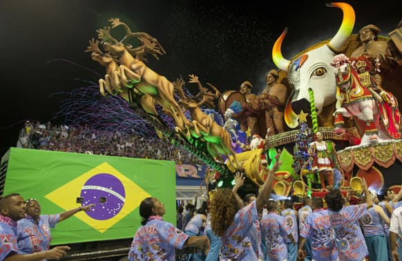 Dancers from the Rosas de Ouro samba school surround their float during a carnival parade in Sao Paulo, Brazil.