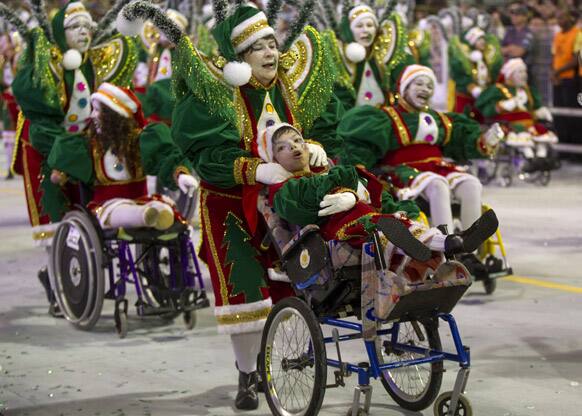 Children with disabilities perform with dancers from the Rosas de Ouro samba school during a carnival parade in Sao Paulo, Brazil.