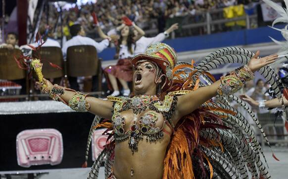 A dancer from the Gavioes da Fiel samba school performs during a carnival parade in Sao Paulo.