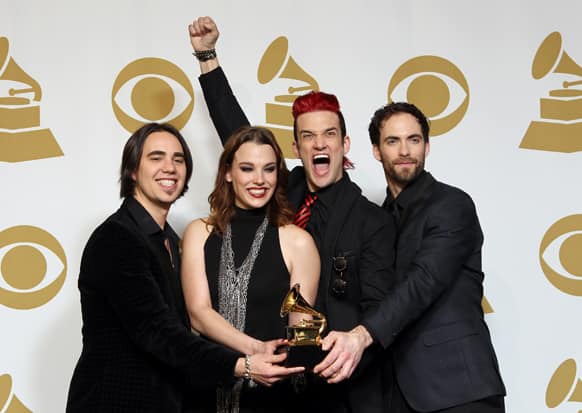 Members of Halestorm, from left, Joe Hottinger, Lzzy Hale, Arejay Hale, Josh Smith pose backstage for the best rock album award for