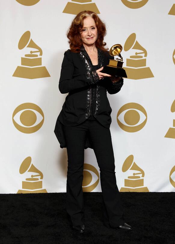 Bonnie Raitt poses backstage with the award for best americana album for