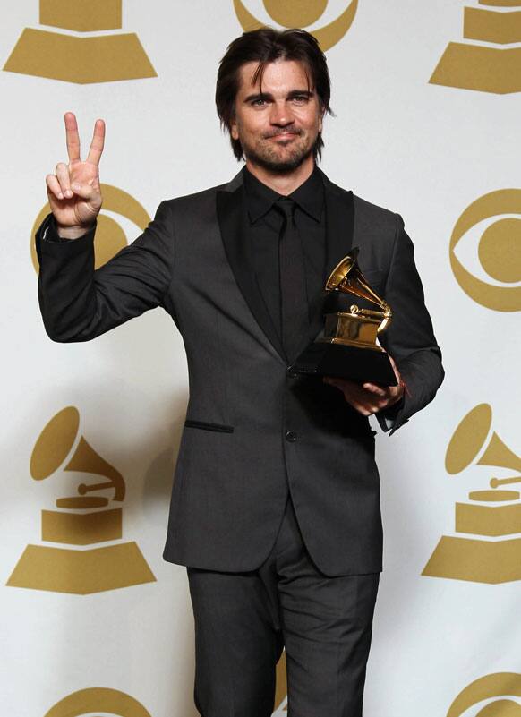 Juanes poses backstage with the award for best Latin pop album for