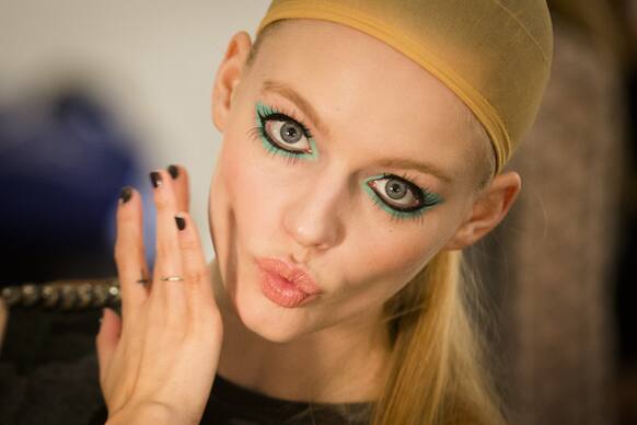 A model is prepared backstage before the Betsey Johnson Fall 2013 collection is shown during Fashion Week in New York.