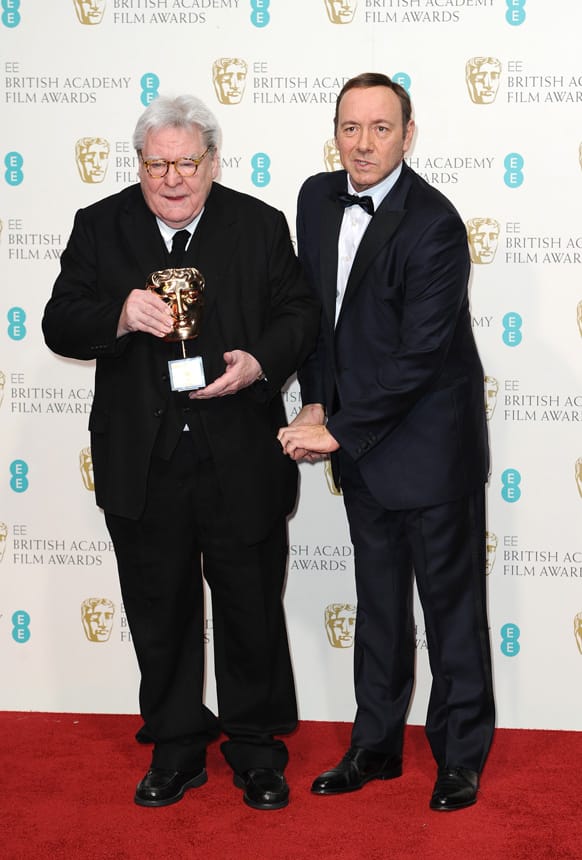 British director Alan Parker, left, with the Fellowship award, and American producer-actor Kevin Spacey pose backstage at the BAFTA Film Awards at the Royal Opera House.