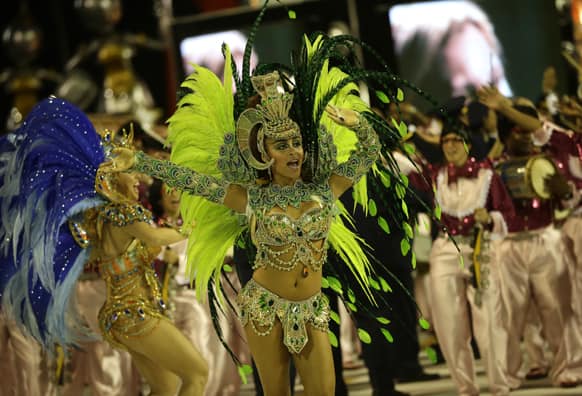 Performers from the Sao Clemente samba school parade during carnival celebrations at the Sambadrome in Rio de Janeiro, Brazil.
