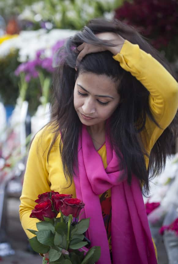 A Pakistani girl buys flowers ahead of Valentine's Day at a floral shop Islamabad. Supporters of Pakistan’s main religious party Jamaat-e-Islami staged a protest against Valentine’s Day on denouncing it as un-Islamic and calling for a “day of modesty” instead.