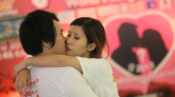 Krittirak Chaikham, left, and Kanokwan Arjkidkorn compete in the World's Longest Continuous Kiss Competition in Pattaya, southeastern Thailand.