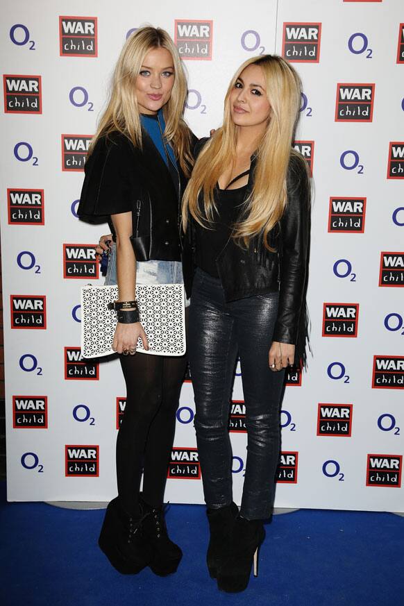 Laura Whitmore and Zara Martin pose for a photograph at the O2 and War Child BRIT Awards Concert with Muse at O2 Shepherds Bush Empire, in London.