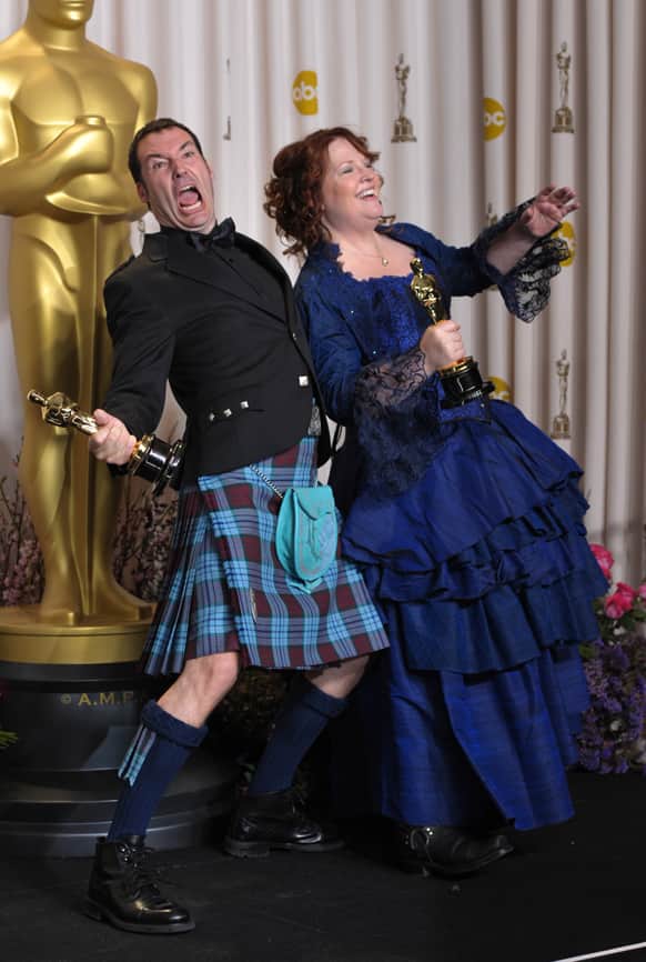 Directors Mark Andrews, left, and Brenda Chapman pose with their award for best animated feature film for