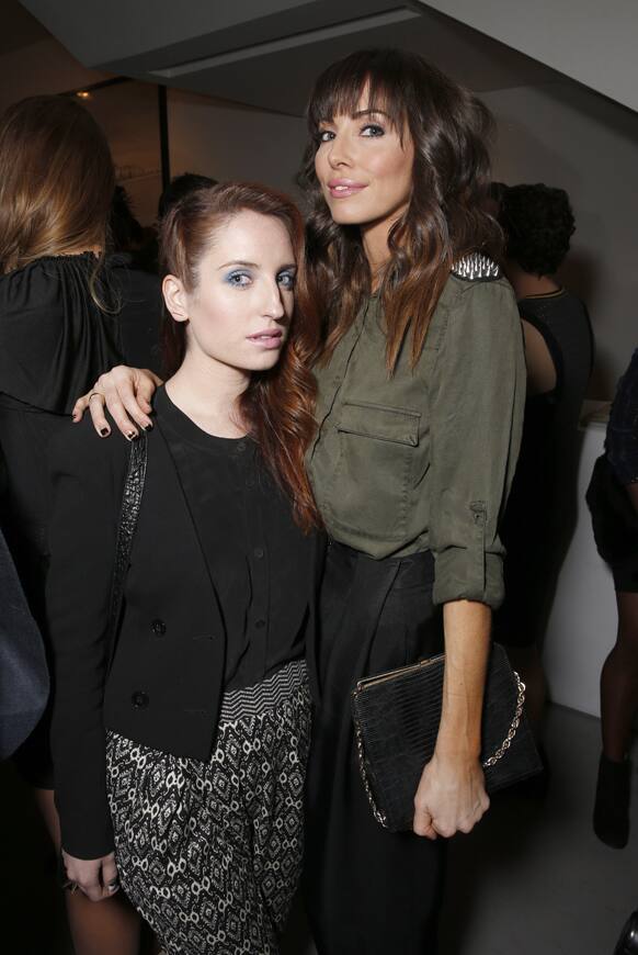 Zoe Lister Jones, left, and Whitney Cummings salute legend of art and fashion Mario Testino with cocktails by Porton at the Peruvian native's exhibition at Prism in Los Angeles.