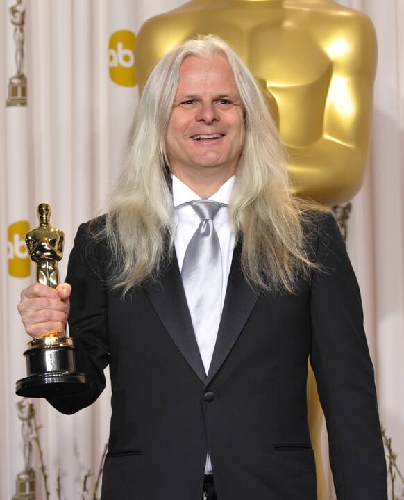 Claudio Miranda poses with his award for best cinematography for