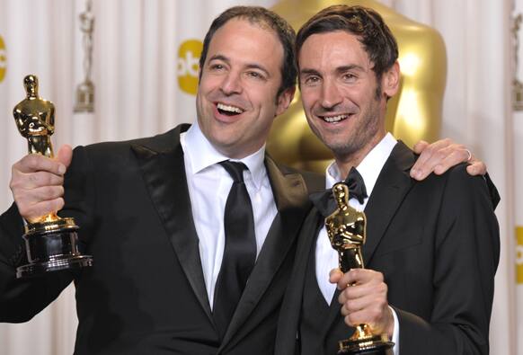 Producer Simon Chinn, left, and actor Malik Bendjelloul pose with their award for best documentary feature for