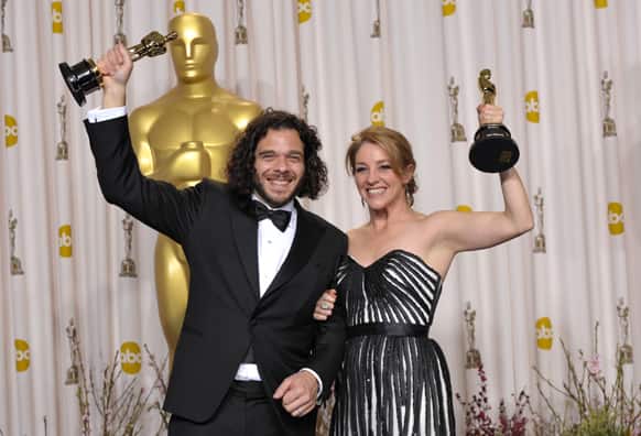 Sean Fine, left, and Andrea Nix Fine pose with their award for best documentary short subject for