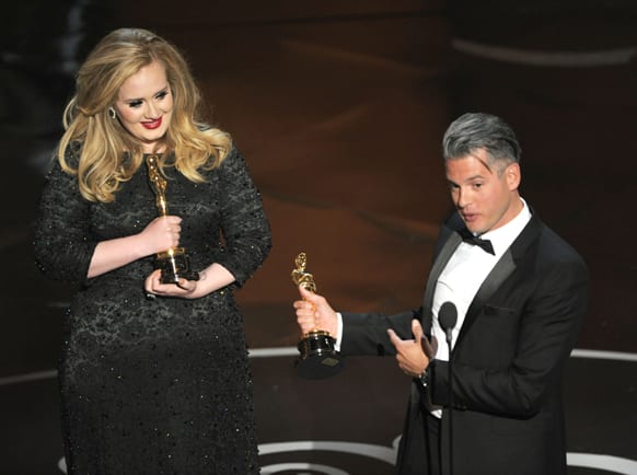 Singer Adele, left, and musician/producer Paul Epworth accept the award for best original song for