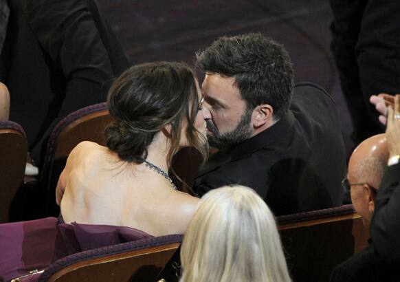 Jennifer Garner, left, kisses husband and director Ben Affleck after