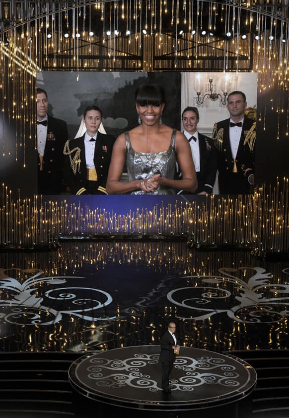 First lady Michelle Obama, appearing on screen, and actor Jack Nicholson present the award for best picture during the Oscars at the Dolby Theatre in Los Angeles.