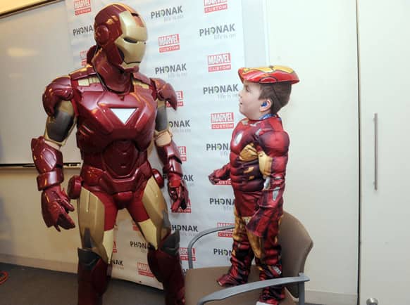 Phonak hearing aid wearer Anthony Smith, 5, of Salem, NH, shares a moment with Marvel's Iron Man, in New York.