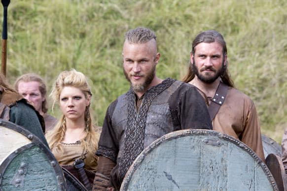 This image released by History shows Katheryn Winnick, as Lagertha, left, Travis Fimmel, as Ragnar, center, and Clive Standen as Rollo in a scene from