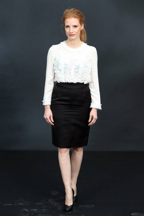 Jessica Chastain poses for photographers as she arrives for Chanel's Fall/Winter 2013-2014 ready to wear collection, in Paris.