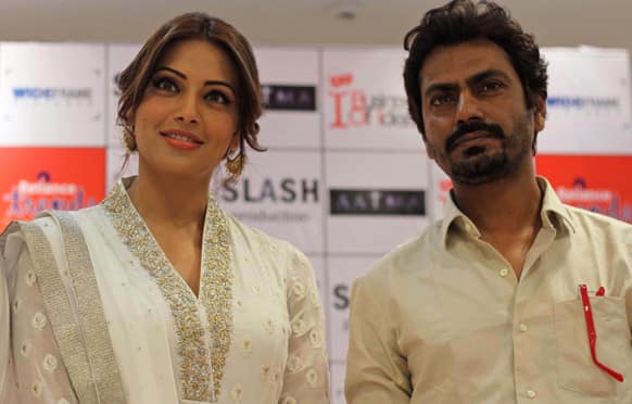 Bipasha Basu and Nawazuddin Siddiqui pose for photographs during a press conference to promote their upcoming movie