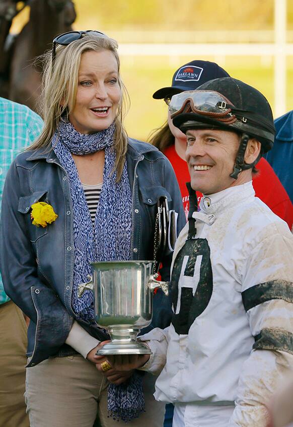 Actress Bo Derek, left, poses with jockey Jon Court after Court and Will Take Charge won the $600,000 Rebel Stakes horse race at Oaklawn Park in Hot Springs, Ark.