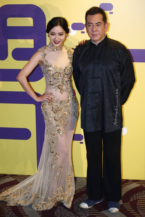 Chinese actress Zhou Chu Chu, left, and Hong Kong actor Anthony Wong pose for the photographers at the red carpet of 37th Hong Kong International Film Festival (HKIFF) Grand Opening in Hong Kong.