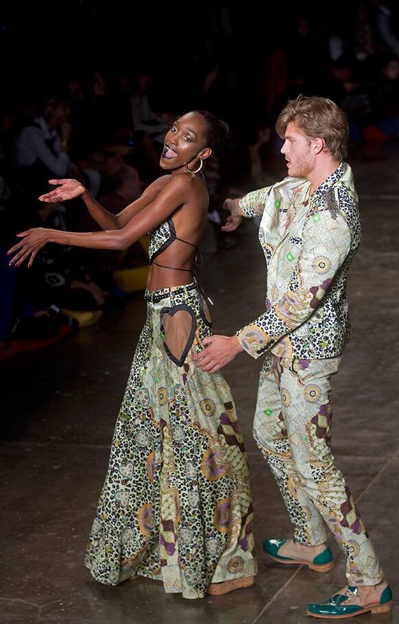 Models dance as they present creations from the Cavalera summer collection during the Sao Paulo Fashion Week.