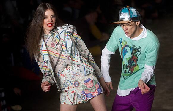 Models dance as they present creations from the Cavalera summer collection during the Sao Paulo Fashion Week.