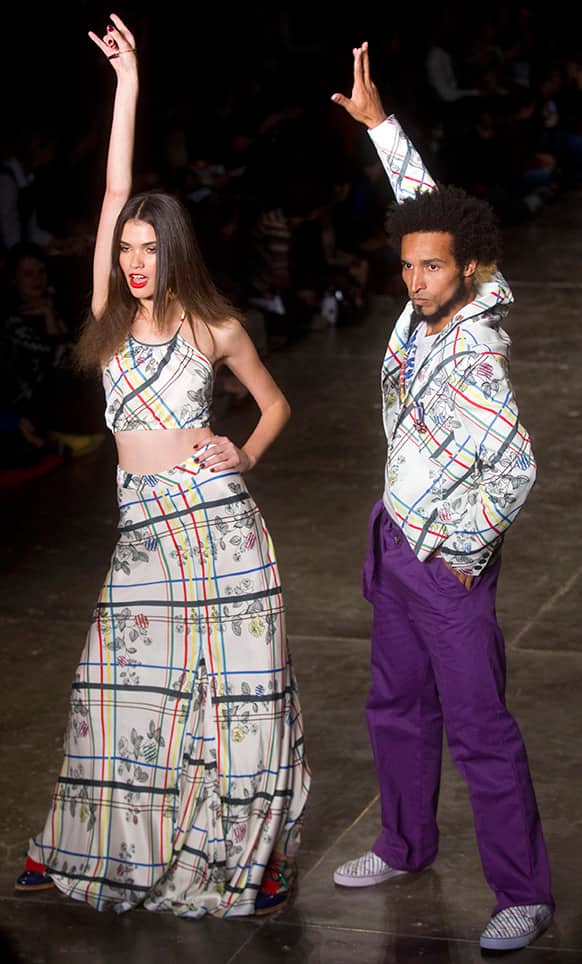 Models dance as they present creations from the Cavalera summer collection during the Sao Paulo Fashion Week.