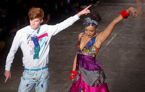 Models dance as they present creations from the Cavalera summer collection during the Sao Paulo Fashion Week.