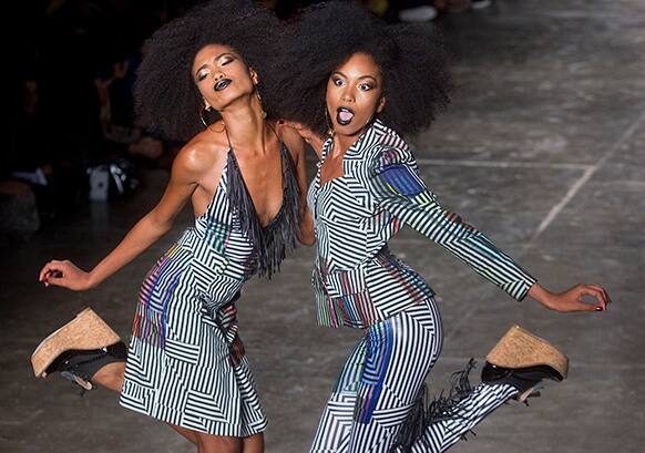 Models dance as they present creations from the Cavalera summer collection during the Sao Paulo Fashion Week in Brazil.