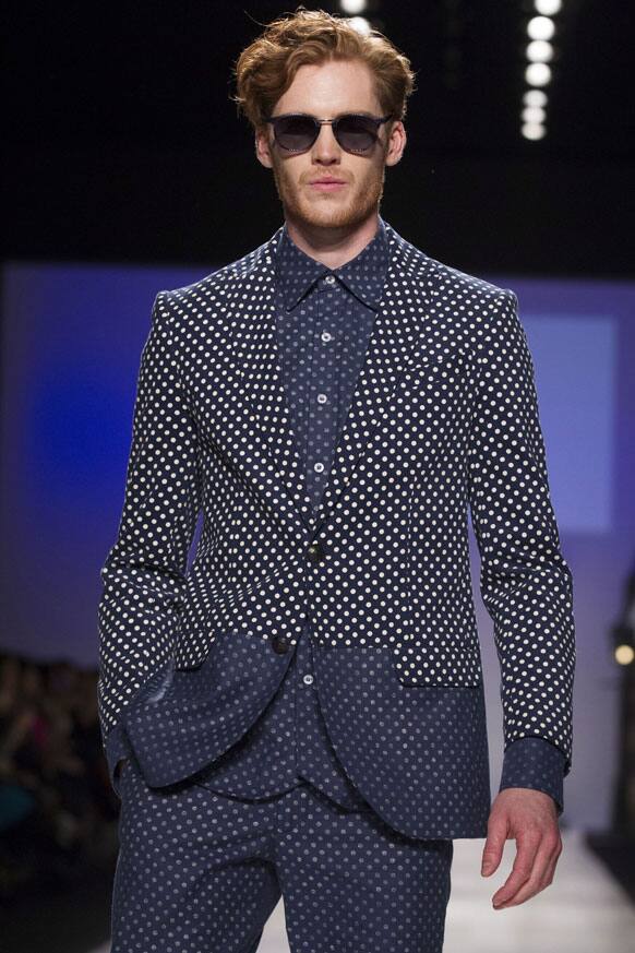 A model wears a creation from Bustle while walking the runway during Toronto Fashion Week in Toronto.