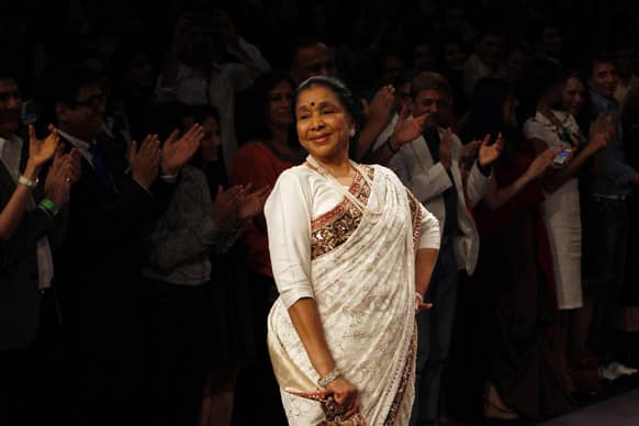 Veteran Bollywood singer Asha Bhosale showcases a creation of Manish Malhotra during the first day of Lakme fashion week, Mumbai.