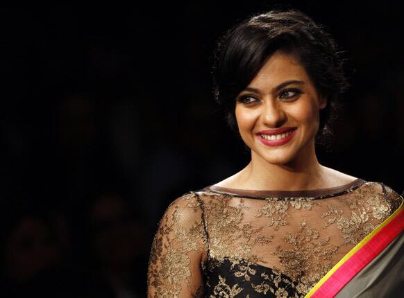 Bollywood Actress Kajol showcases a creation by Manish Malhotra during the first day of Lakme fashion week, Mumbai.