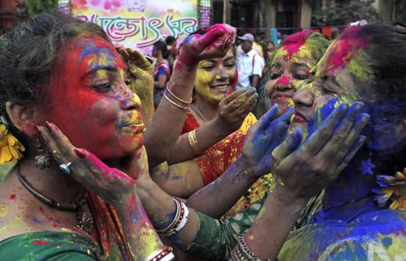 Students smear each other's faces with colored powder as they celebrate Holi, the Hindu festival of colors, at Rabindra Bharati University campus in Kolkata.
