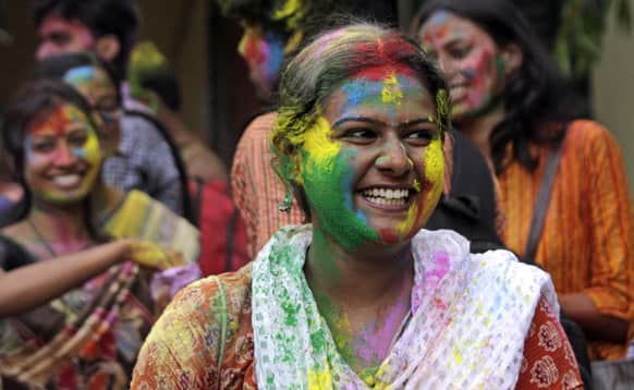 Student, face smeared with colored powder, celebrates Holi, the Hindu festival of colors, at Rabindra Bharati University campus in Kolkata.