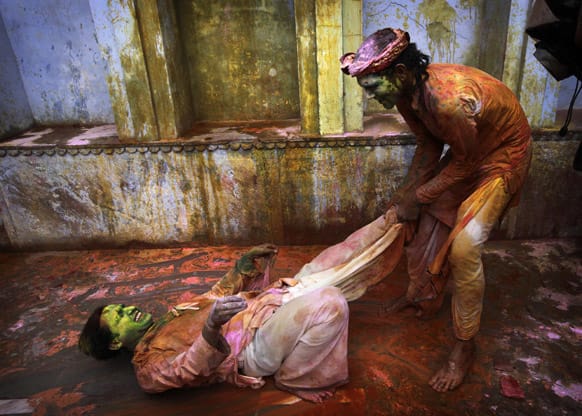 Hindu devotees smeared with colors play at the Nandagram temple famous for Lord Krishna and his brother Balram, during Lathmar holy festival, in Nandgaon 120 kilometers ( 75 miles) from New Delhi.