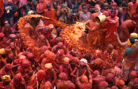 Villagers from Nandgaon throw colored water on the villagers from Barsana as they arrive at the Nandagram temple famous for Lord Krishna and his brother Balram, during Lathmar holy festival, in Nandgaon 120 kilometers ( 75 miles) from New Delhi.