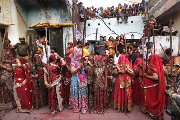 Women from Nandgaon wait for the villagers from Barsana village during Lathmar Holi festival, in Nandgaon.