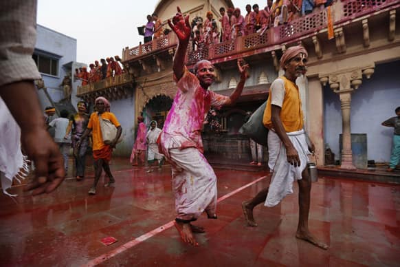 Hindu devotee covered in color dances as he arrives at the Nandagram Temple famous for Lord Krishna in Nandgaon 120 kilometers ( 75 miles) from New Delhi.