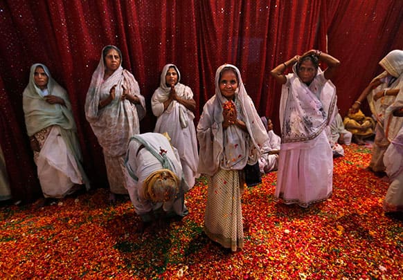 Indian widows pray during Holi celebrations, or the festival of colors, at an event organized by the NGO Sulabh at the Meera Sahbhagini Ashram in Vrindavan.