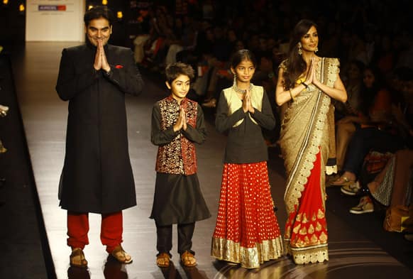 Bollywood actor Arbaaz Khan, left, his son Arhaan Khan and wife Malaika Arora Khan, right, along with young environmental activist Diksha Pawar display creations by Vikram Phadnis during the Lakme Fashion Week in Mumbai.